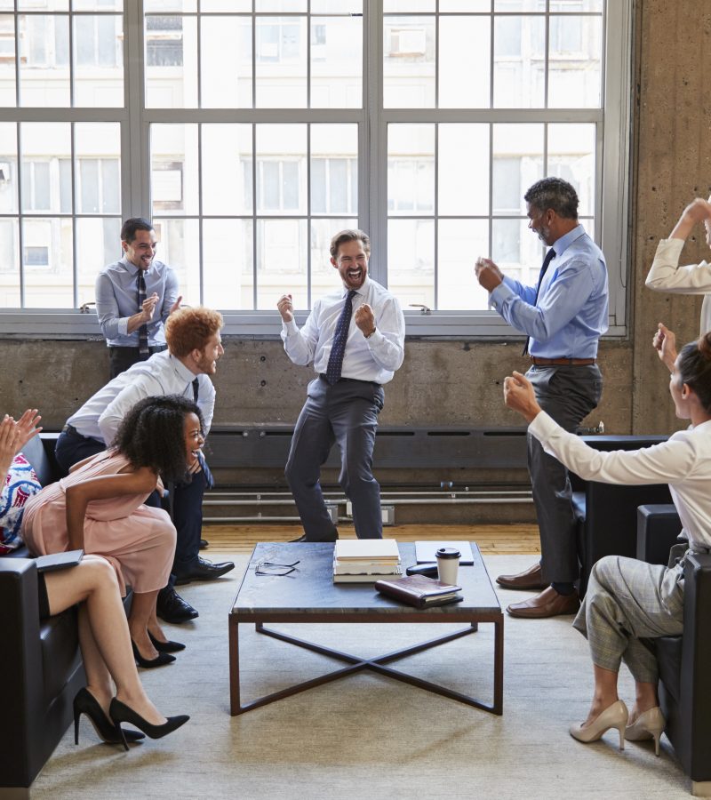 Business team celebrate hitting target at informal meeting